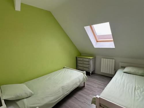 a attic room with two beds and a window at Ancienne longère rénovée avec piscine privative et animaux admis - FR-1-489-201 in Échassières