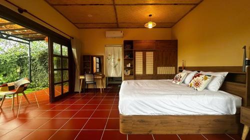 a bedroom with a large bed in a room at Yên Retreat & Cafe in Cà Mau