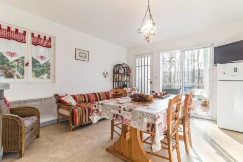 a kitchen and living room with a table and chairs at Il était une fois in Champeau