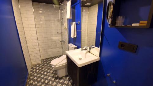 a bathroom with a sink and a toilet and blue walls at THINK HOTEL in Konya