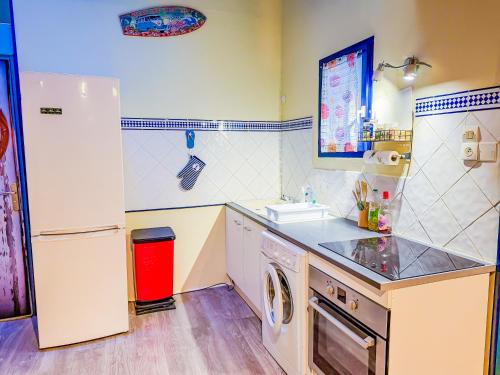 a kitchen with a white refrigerator and a dishwasher at Appartement 5 personnes Centre d'Agde in Agde