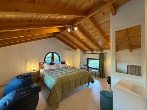 a bedroom with a large bed and a window at Cyherbia Botanical Park & Labyrinth in Avgorou