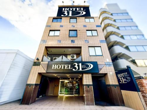 a building with a hotel sign on it at HOTEL 31 in Funabashi