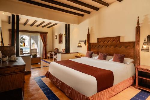 a bedroom with a large bed in a room at Grand Makadi - Couples and Families Only in Hurghada