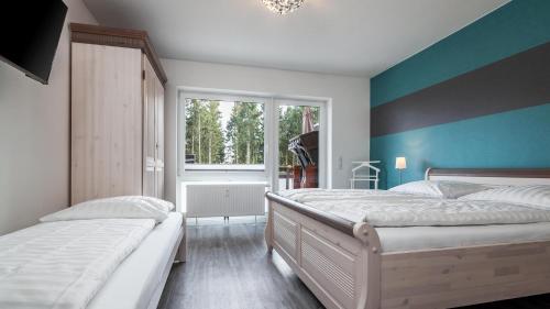 two beds in a room with blue and white walls at Golfresidenz B 106 in Grömitz