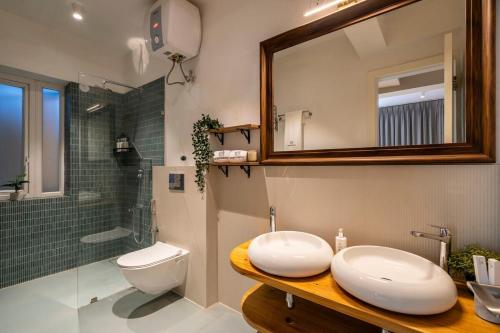a bathroom with a sink and a toilet and a shower at Staymaster Solintra C301 - Pool in Nerul