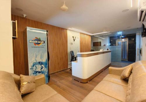 a living room with a couch and a counter at Hotel Vamshi Grand in Lingampalli