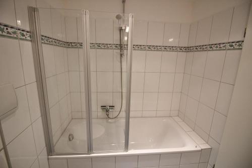 a bathroom with a shower and a tub at Golfresidenz B 109 in Grömitz