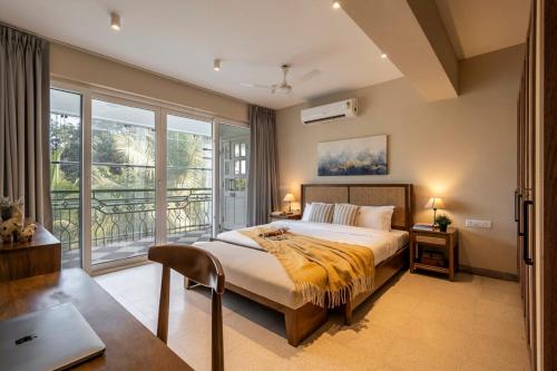 a bedroom with a bed and a large window at Staymaster Solintra C301 - Pool in Nerul