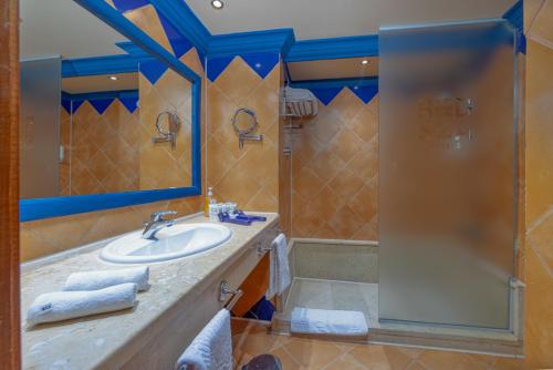 a bathroom with a sink and a shower at Grand Makadi - Couples and Families Only in Hurghada