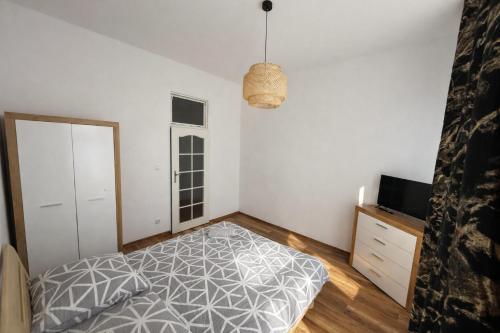 a bedroom with a bed and a television in it at Apartament Panorama Centrum in Przemyśl