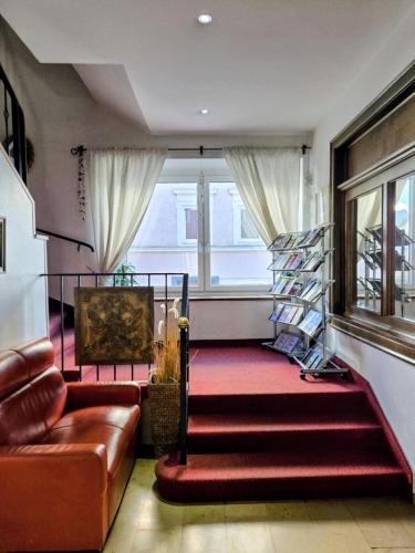 a living room with a couch and a stair case at DAD Vogelweiderhof Rooms in Salzburg