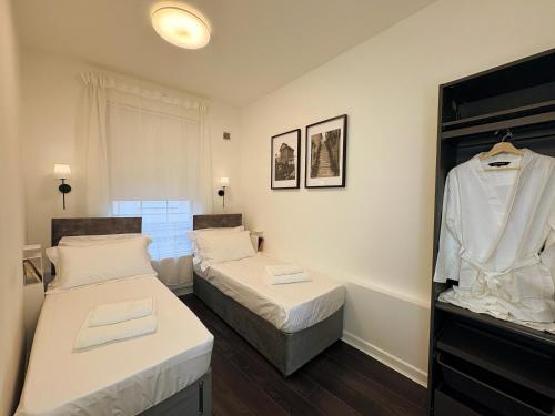 a room with two beds and a closet at The Pottergate Residence - Norwich Lanes in Norwich