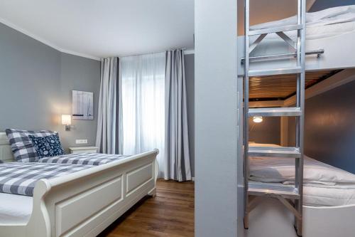 a bedroom with a bunk bed and a ladder at Golfresidenz B 001 in Grömitz