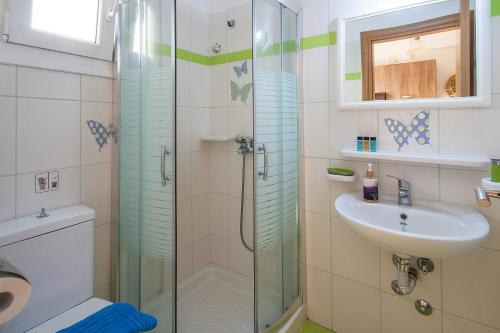 a bathroom with a shower and a sink at Syrainas studios in Troulos