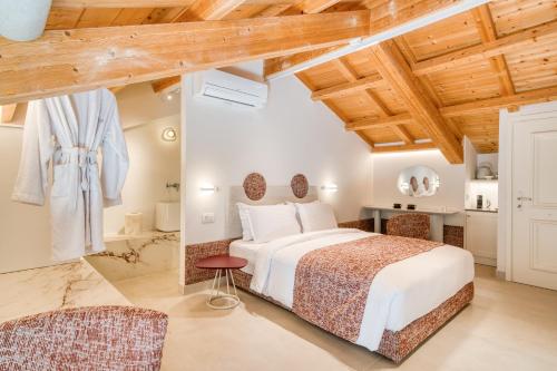 a bedroom in a villa with a bed at Nalia Suites in Nafplio