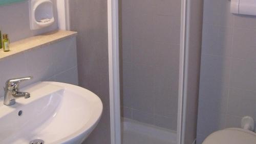 a bathroom with a toilet and a sink and a shower at Hotel degli Ulivi in Vieste
