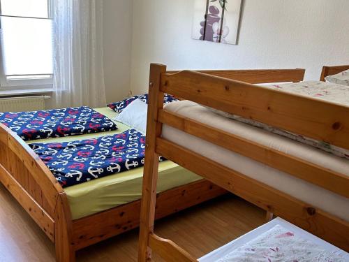 a bedroom with two bunk beds and a window at Ferienwohnungen am Wald in Lütow