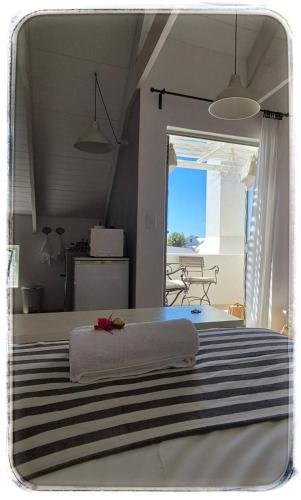a bedroom with a bed with a towel on it at Ciao in Paternoster