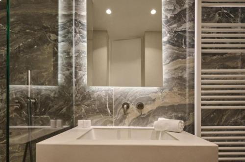 a bathroom with a sink and a mirror at Teria Collection in Porto Heli