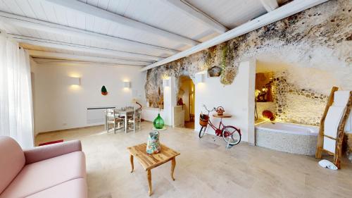 a living room with a couch and a table and a tub at Masseria Torre Rossa in Fasano