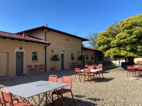 a group of tables and chairs in front of a building at La Corte Nascosta Volpedo in Volpedo
