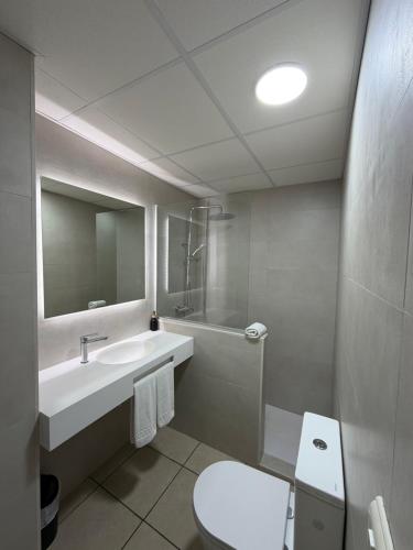 a bathroom with a sink and a toilet at Apartamentos Tramuntana in San Antonio