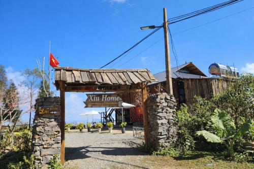 a sign for a new home in front of a building at Xìu Homestay Tà Xùa in Bắc Yên