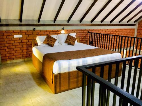 a bedroom with a bed in a brick wall at Villa viverra in Polonnaruwa