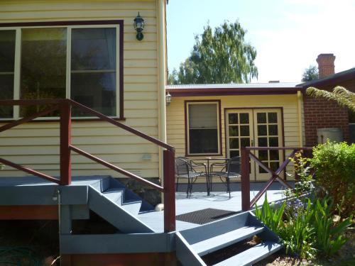 a porch with stairs leading to a house at Donalea Bed and Breakfast & Riverview Apartment in Castle Forbes Bay