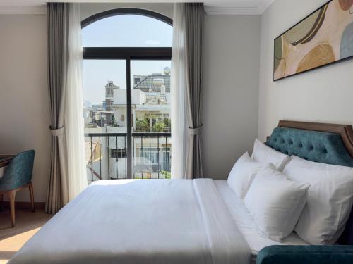a bedroom with a bed and a large window at CityHouse TERA The S in Ho Chi Minh City