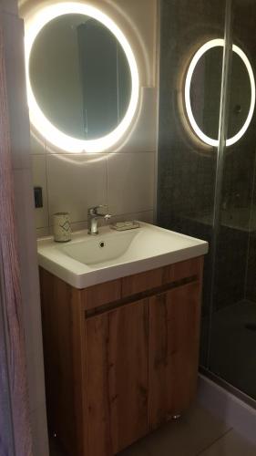 a bathroom with a sink and a mirror and a shower at Немирівель in Nemirov