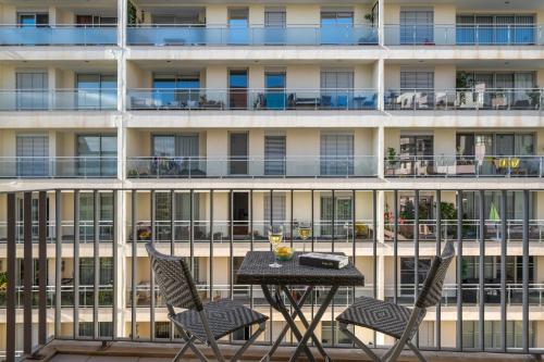 a table and chairs on the balcony of a building at Camélia's Apartment I by An Island Apart, Lda in Funchal