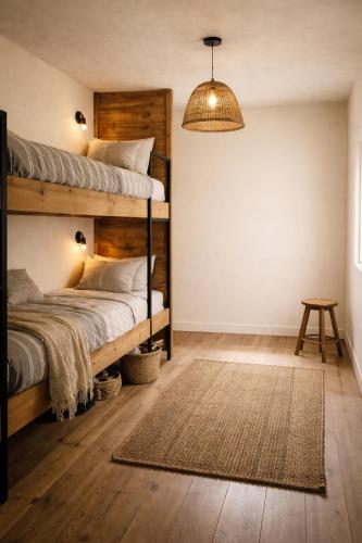 a bedroom with two bunk beds and a lamp at The Happy Homestay in Nāmkom