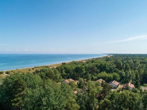 an aerial view of a house and the beach at 6 person holiday home in Væggerløse in Bøtø By