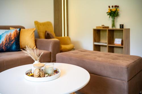 a living room with a coffee table and a couch at Apartma pod macesnom in Jesenice