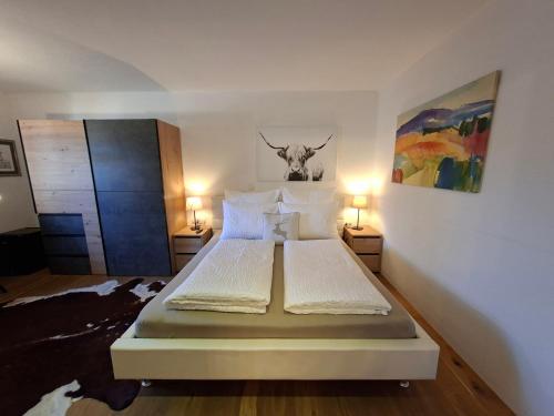 a bedroom with a bed with a cow head on the wall at Haus Miriam in Mieming