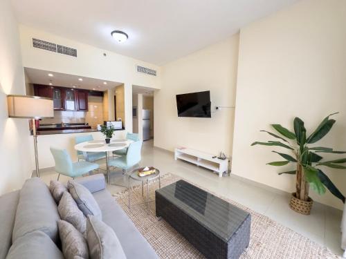 a living room with a couch and a table at Royal Breeze Sea View One Bedroom Apartment in Ras al Khaimah