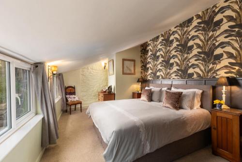 a bedroom with a large bed and a large window at Pilgrim Corner in Minehead