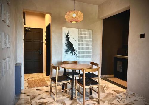 a dining room with a wooden table and chairs at Irama Kopa - Glory Beach Resort in Port Dickson