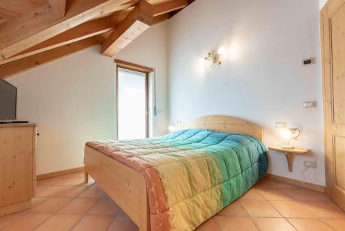 a bedroom with a bed and a television in it at Green house in Mezzaselva