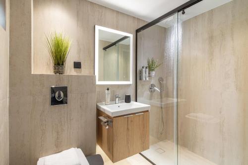 a bathroom with a sink and a shower at Marianthi Apts by Estia in Platanes