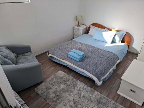 a small bedroom with a bed and a couch at Bellas place in Yambol