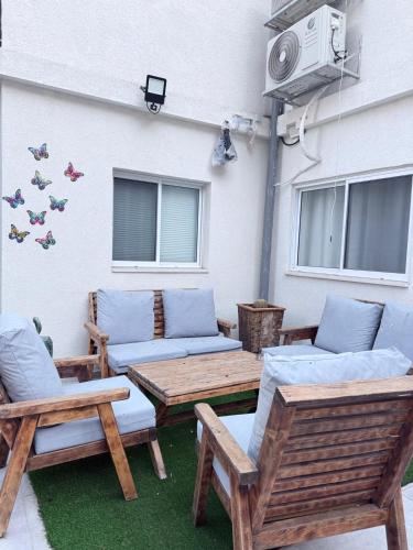 a patio with couches and chairs and a table at Urban garden loft 3 in Haifa