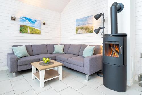 a living room with a couch and a fireplace at Nordstern in Schönberger Strand