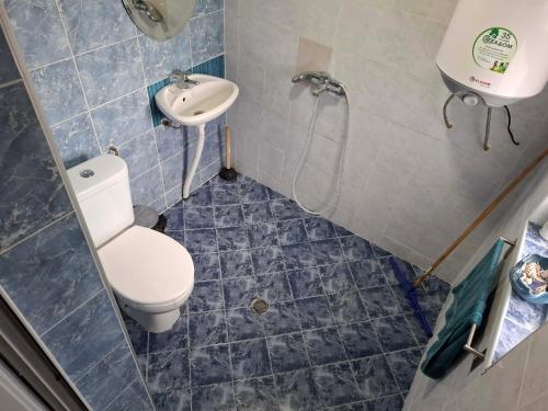 a bathroom with a toilet and a sink at Bellas place in Yambol