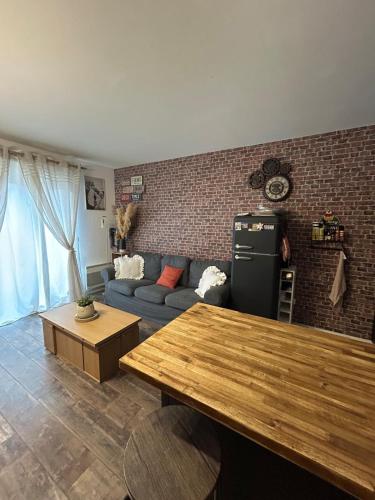 a living room with a couch and a table at Studio loft city center in Tarnos