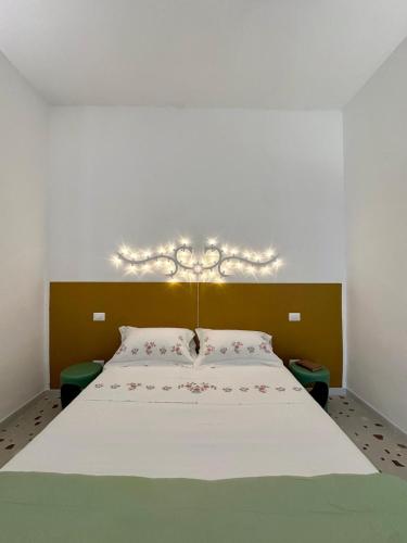 a bedroom with a large bed with lights on it at Convers'Amo Home in Conversano