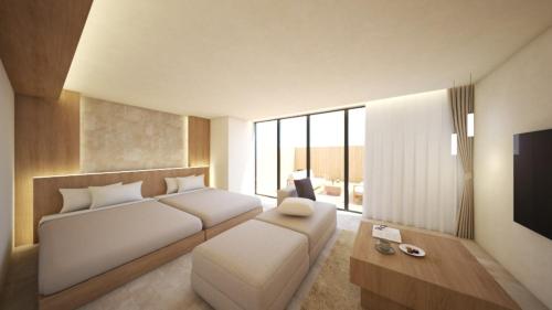 a bedroom with a bed and a couch and a tv at New Grand Hotel in Shinjo