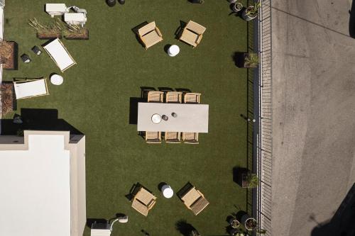 an overhead view of a lawn with tables and chairs at Monarco Executive Rooms in Rhodes Town